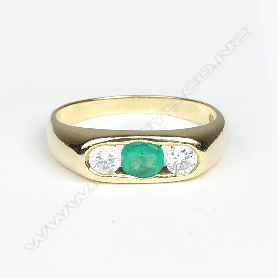 An 18ct. yellow gold emerald and diamond dress ring Image 1++