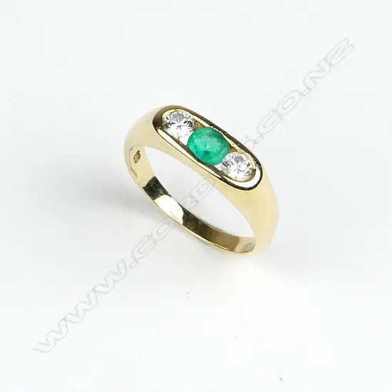 An 18ct. yellow gold emerald and diamond dress ring