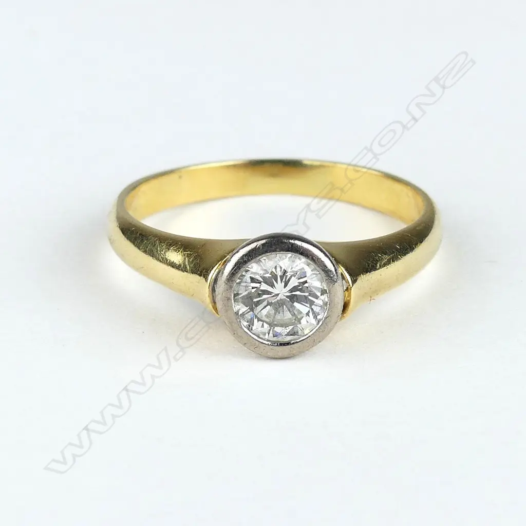 An 18ct yellow and white gold solitaire diamond ring Image 1++