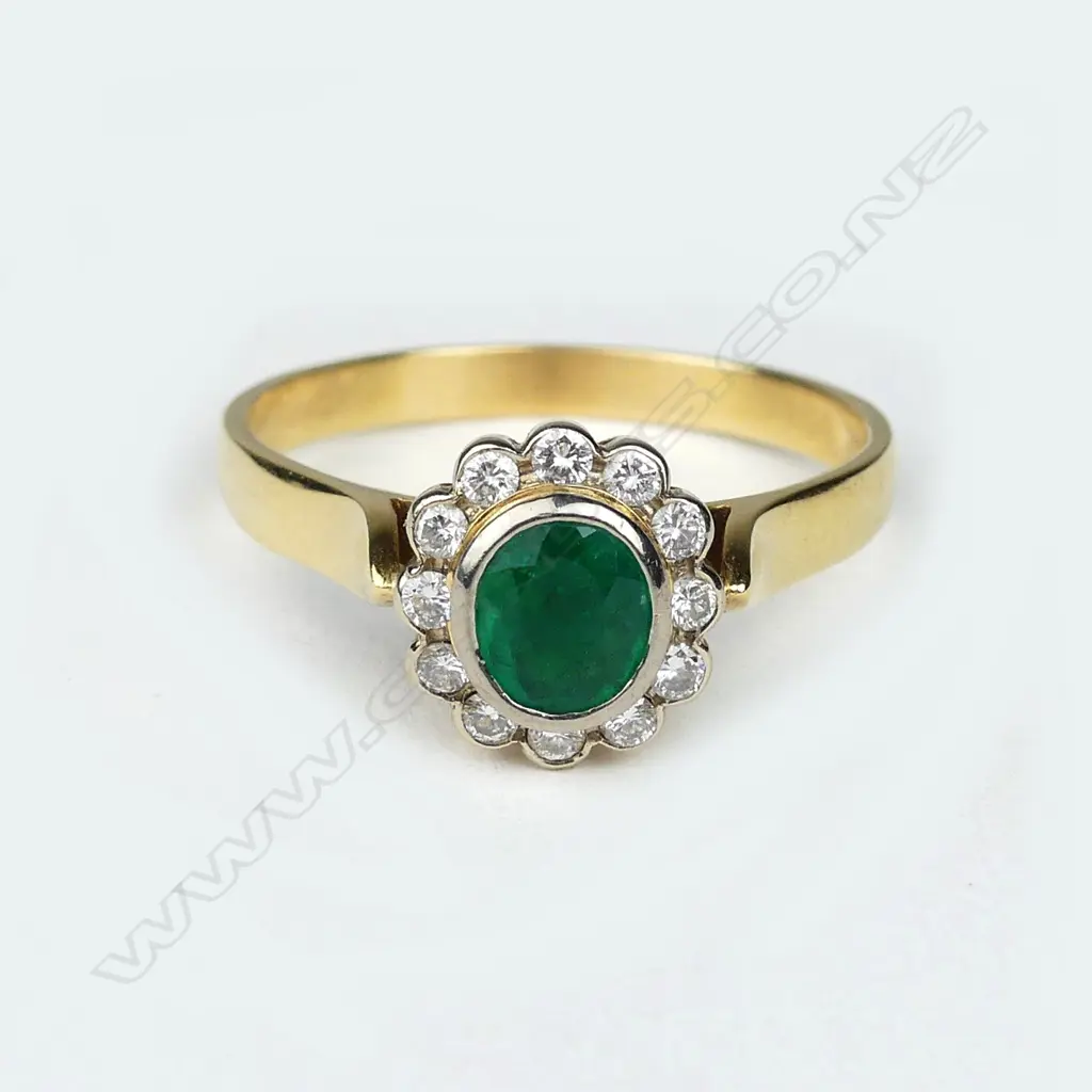 An 18ct gold emerald and diamond ring Image 1++