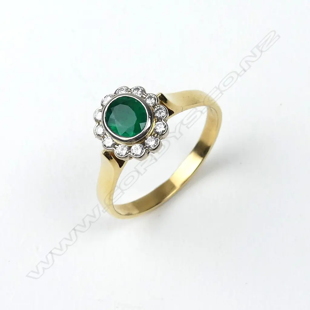 An 18ct gold emerald and diamond ring Image 1++