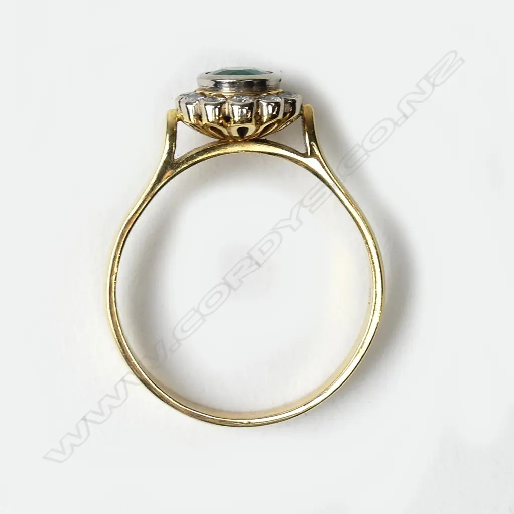 An 18ct gold emerald and diamond ring Image 1++