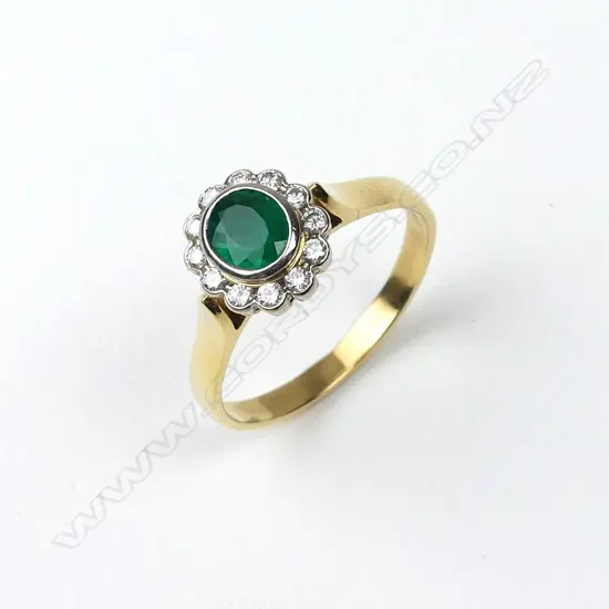 An 18ct gold emerald and diamond ring