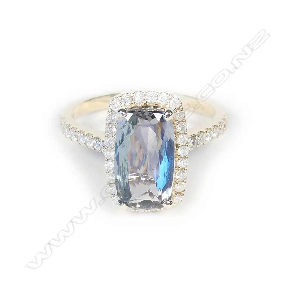 A 14ct gold tanzanite and diamond halo ring Image 1++