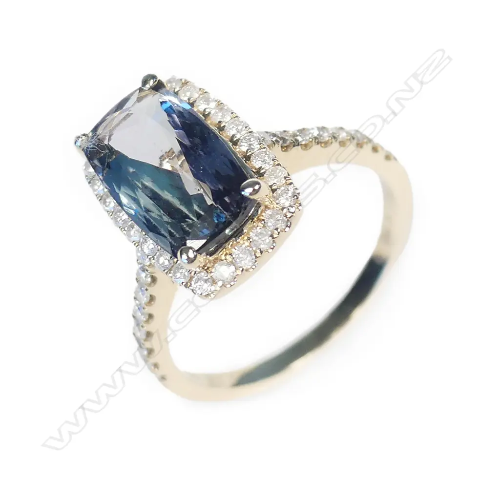 A 14ct gold tanzanite and diamond halo ring Image 1++