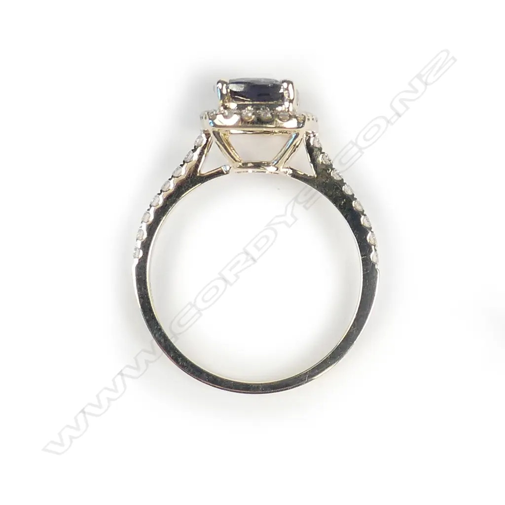A 14ct gold tanzanite and diamond halo ring Image 1++