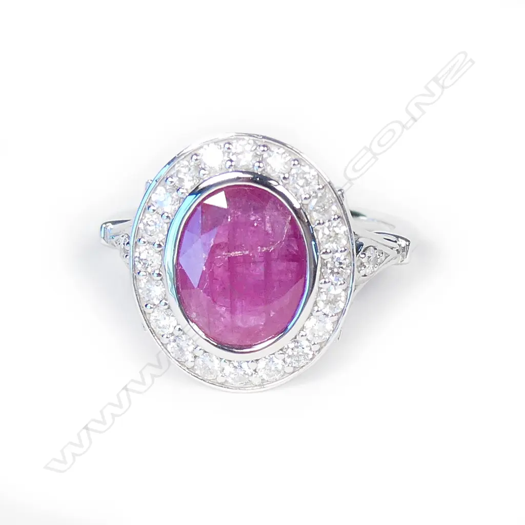 A 14ct white gold ruby and diamond halo ring Image 1++