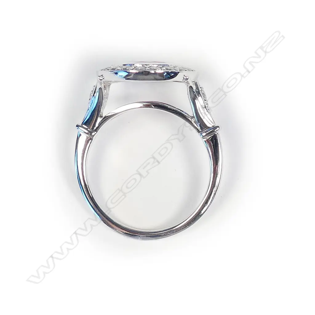 A 14ct white gold ruby and diamond halo ring Image 1++