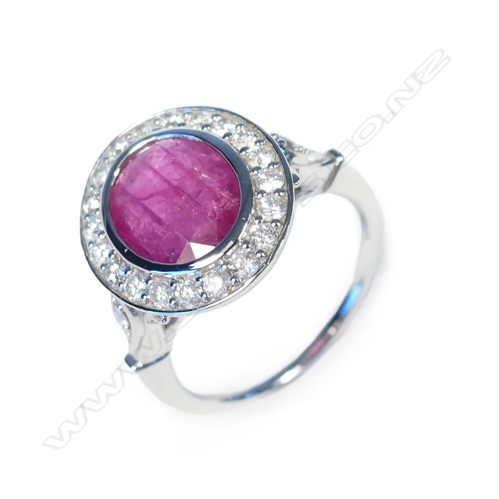A 14ct white gold ruby and diamond halo ring Image 1++