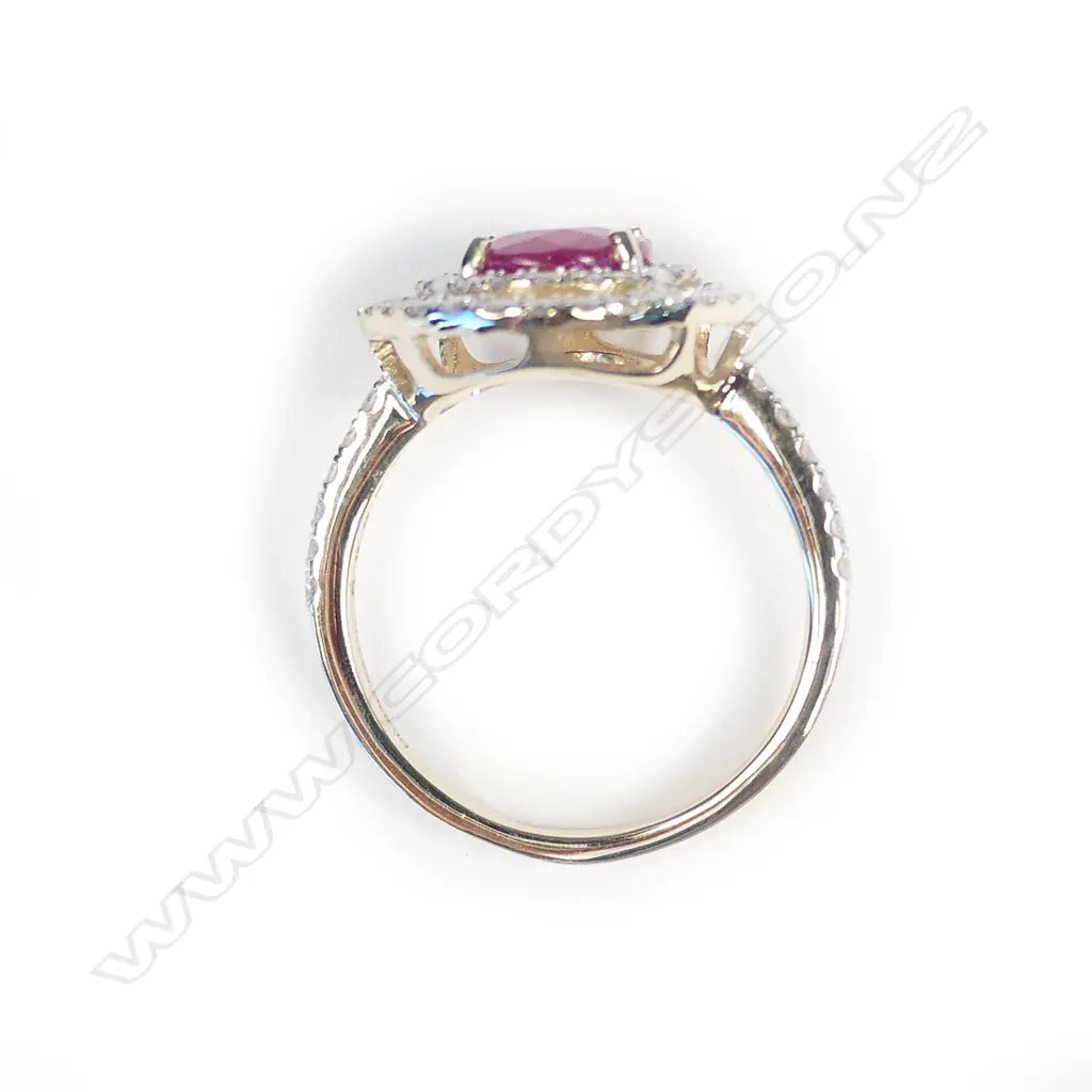 A 14ct white gold ruby and diamond halo ring Image 1++
