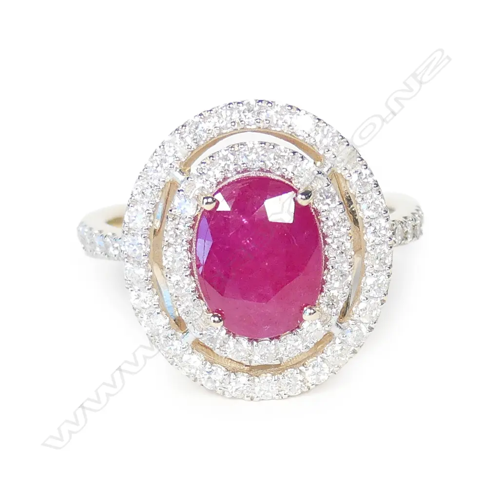 A 14ct white gold ruby and diamond halo ring Image 1++