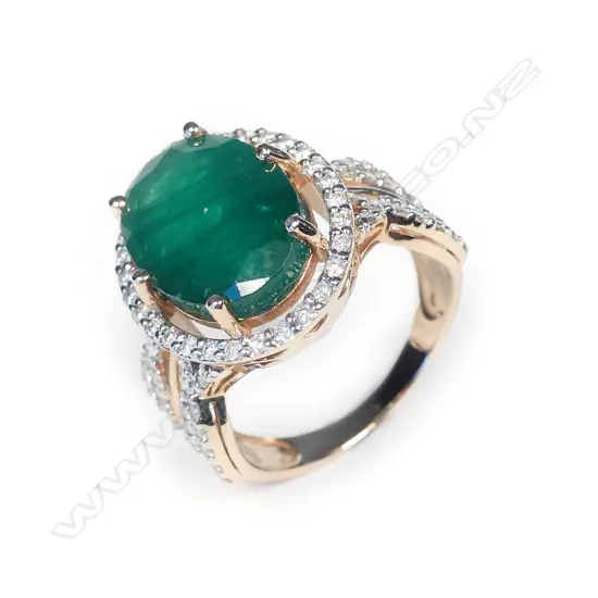 A 14ct rose gold emerald and diamond ring