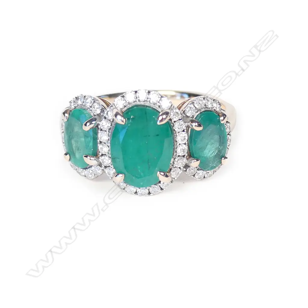 A 14ct rose gold emerald and diamond trilogy ring Image 1++