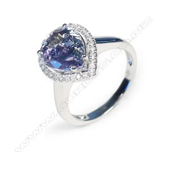 A 14ct white gold tanzanite and diamond halo ring
