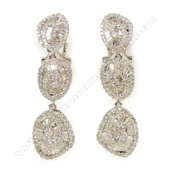 A pair of modern 18ct. white gold and diamond retro stylised triple chandelier drop earrings