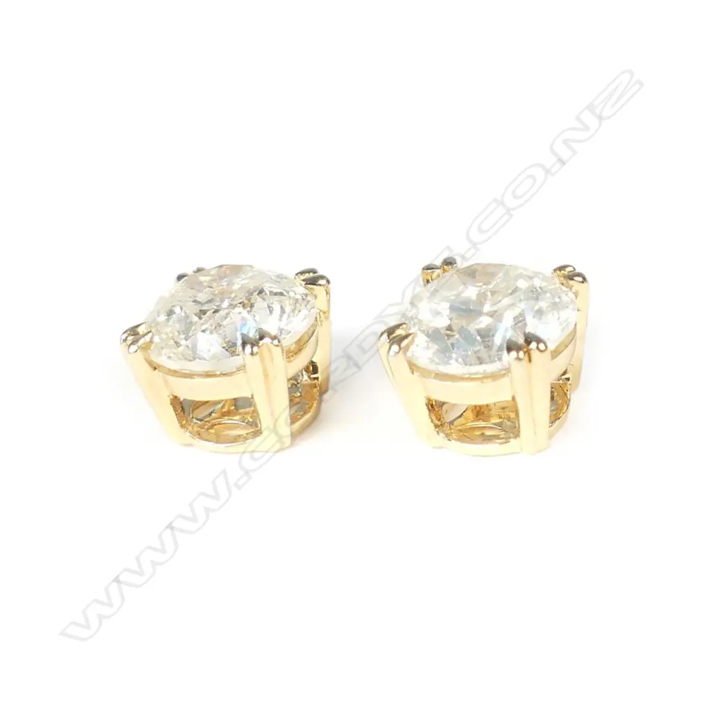 A pair of 18ct gold and diamond stud earrings Image 1++