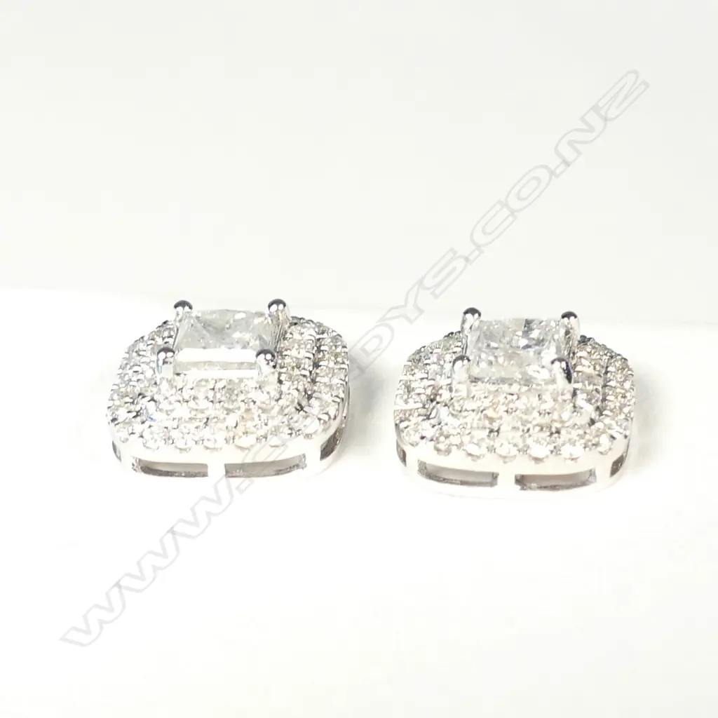 A pair of 14ct white gold and diamond stud earrings Image 1++