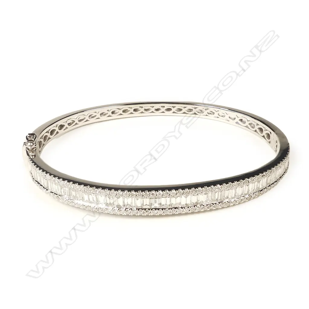 A modern 18ct. white gold and multi-diamond set hinged snap bangle Image 1++