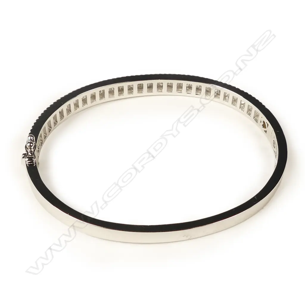 A modern 18ct. white gold and multi-diamond set hinged snap bangle Image 1++