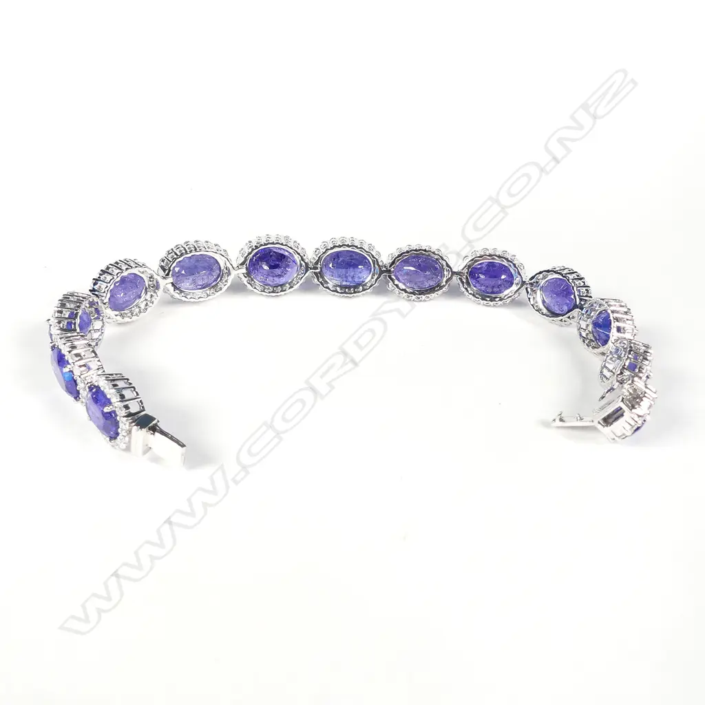 A platinum tanzanite and diamond halo tennis bracelet Image 1++