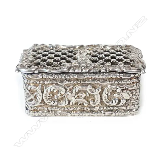 A small silver box with trellis pierced hinged lid