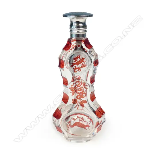 A 19thC French silver topped ruby flashed clear glass scent bottle