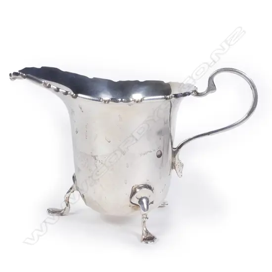 A silver cream jug