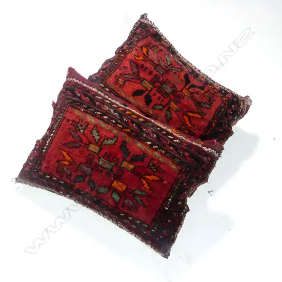Two cushions made from antique Persian rugs