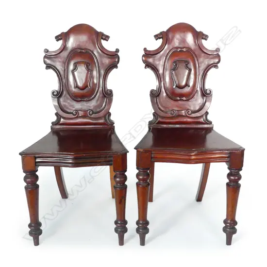 A pair of Victorian mahogany hall chairs