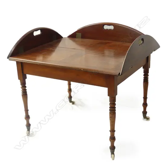 A mahogany butler’s tray top table