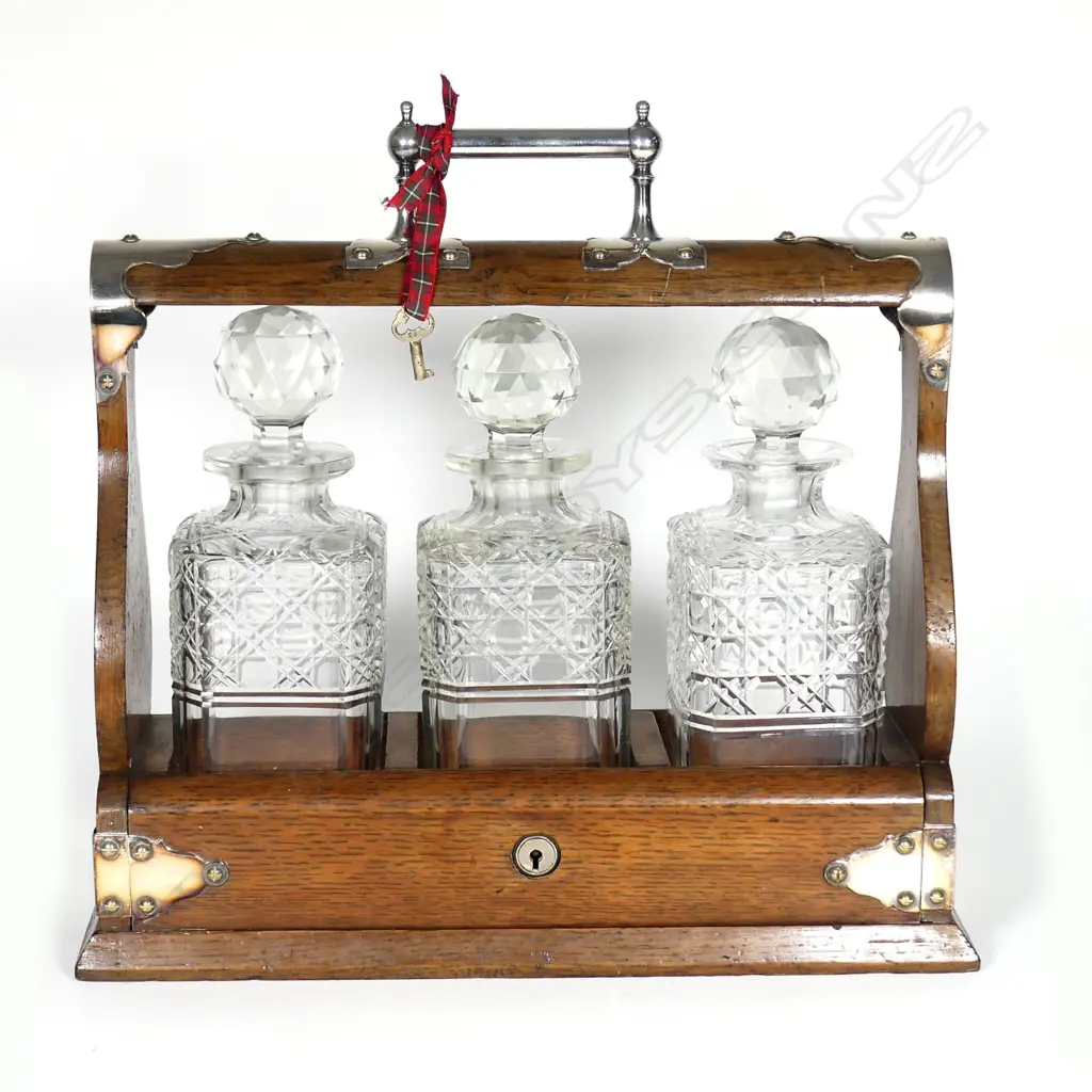 An Edwardian oak and silver plate tantalus Image 1++