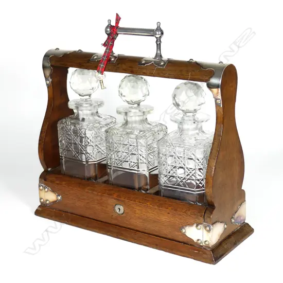 An Edwardian oak and silver plate tantalus