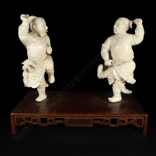A pair of Chinese Qing finely carved solid ivory 'fighting' figures