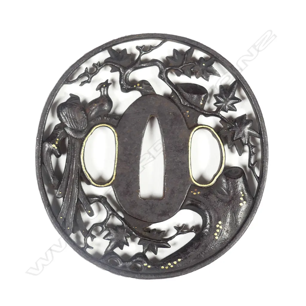 A circular iron tsuba with sculpted filigree design Image 1++
