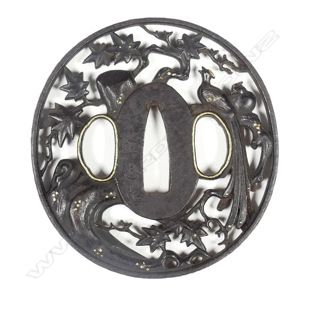 A circular iron tsuba with sculpted filigree design Image 1++
