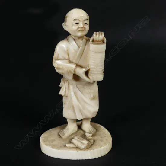 A small Japanese ivory okimono of a man