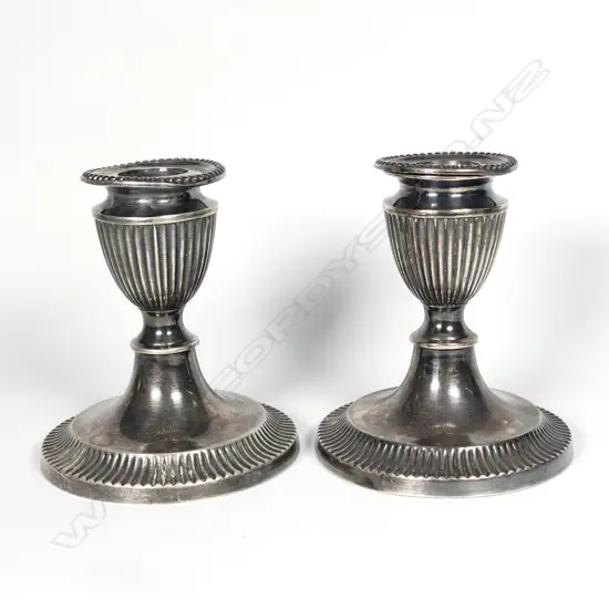 A pair of Edwardian silver candlesticks