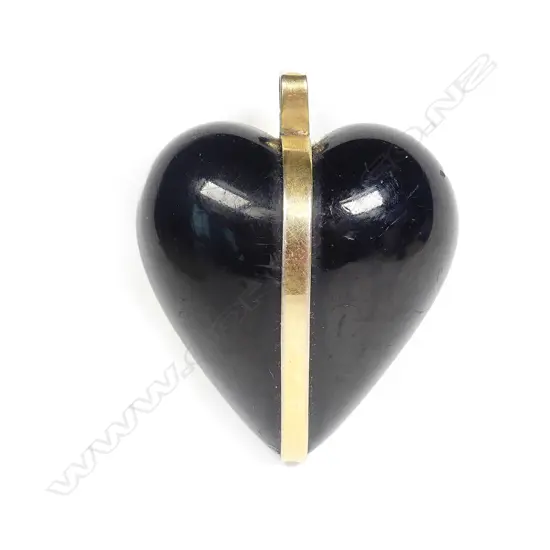 An early 20thC 9ct. gold mounted puff heart jet carved pendant