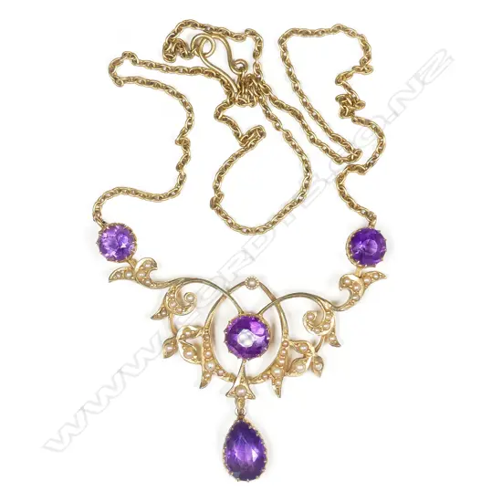 A c.1890 Victorian 15ct yellow gold amethyst and seed pearl scrolling pendant on chain