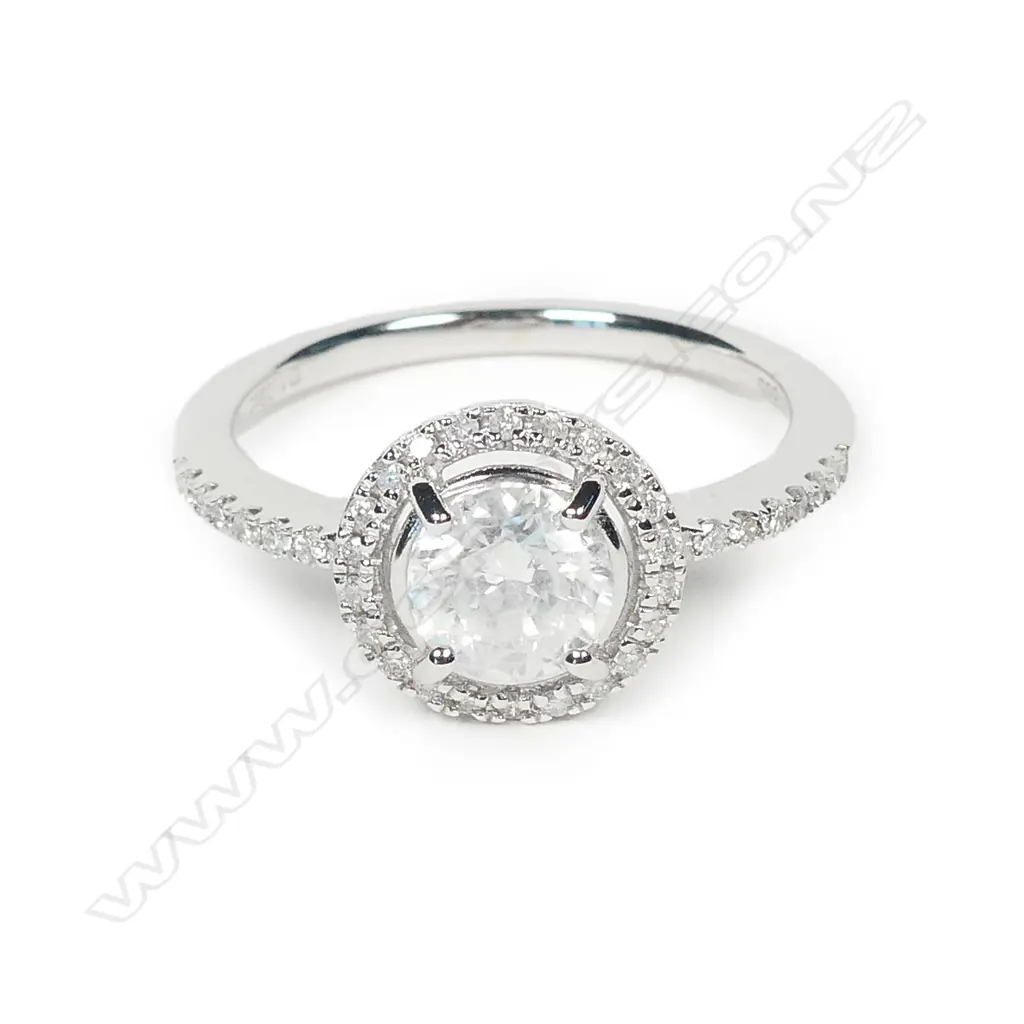 A 14ct white gold and diamond halo ring Image 1++