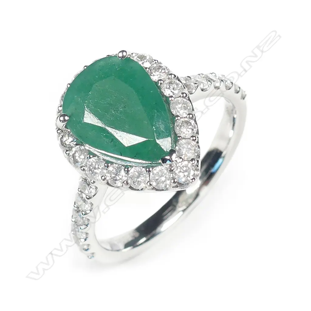 A 14ct white gold emerald and diamond halo ring Image 1++