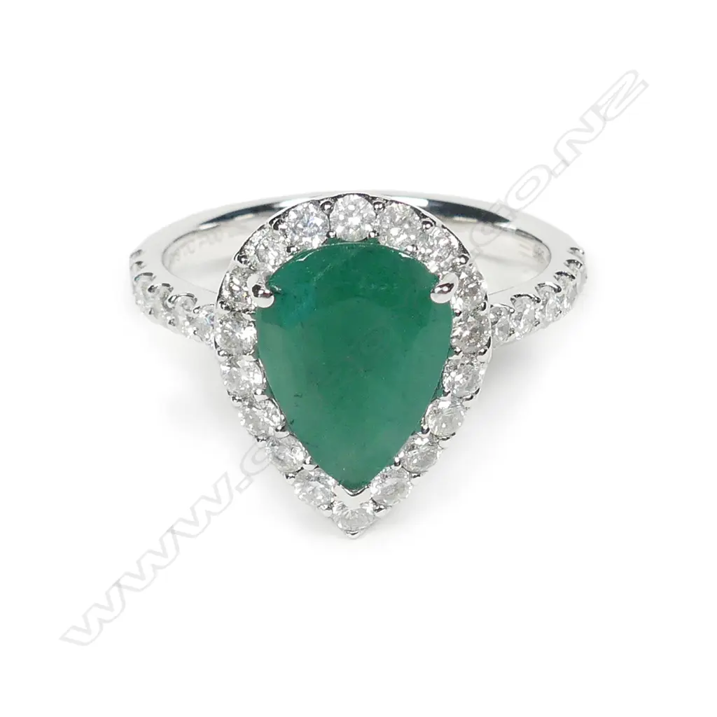 A 14ct white gold emerald and diamond halo ring Image 1++