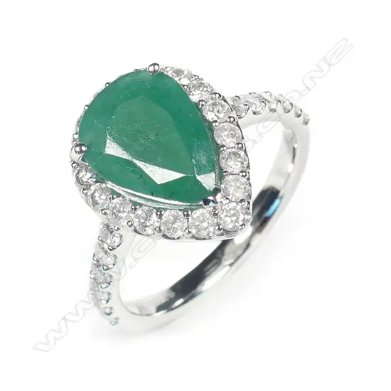A 14ct white gold emerald and diamond halo ring