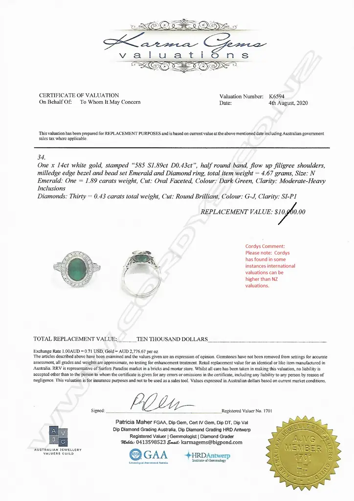 A 14ct white gold emerald and diamond halo ring Image 1++