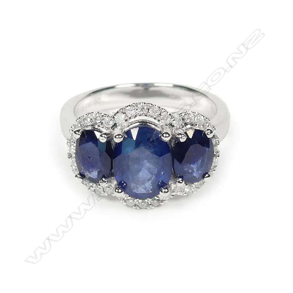 A 14ct white gold sapphire and diamond trilogy ring Image 1++