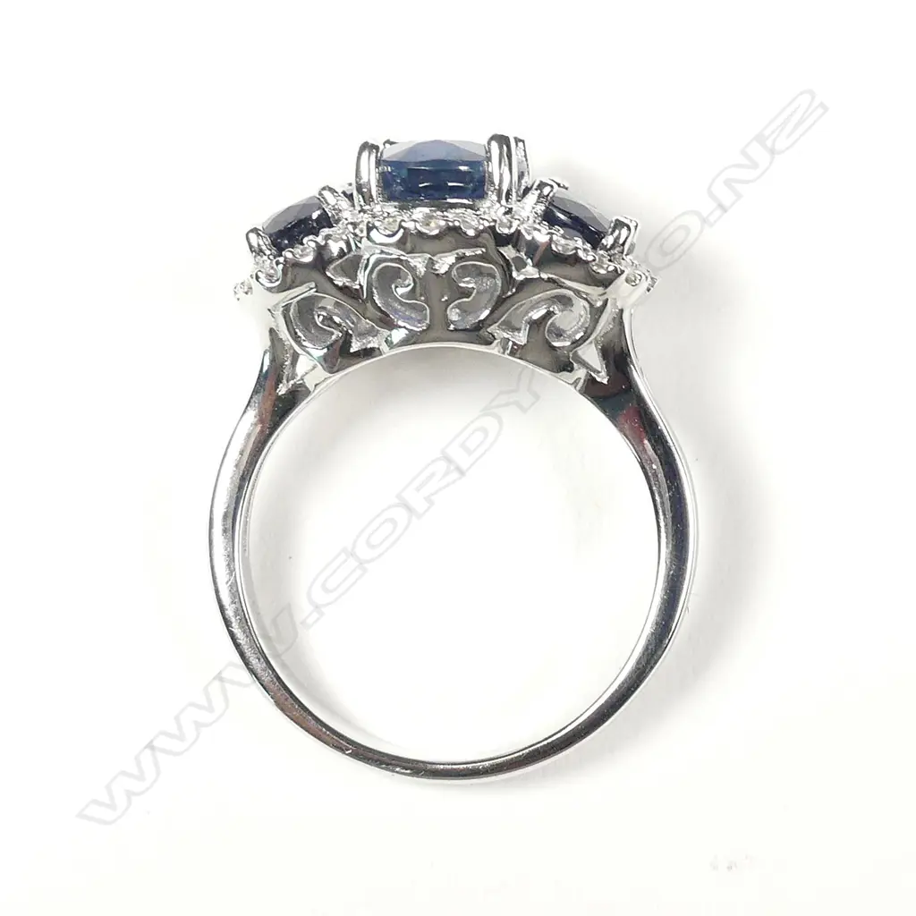 A 14ct white gold sapphire and diamond trilogy ring Image 1++