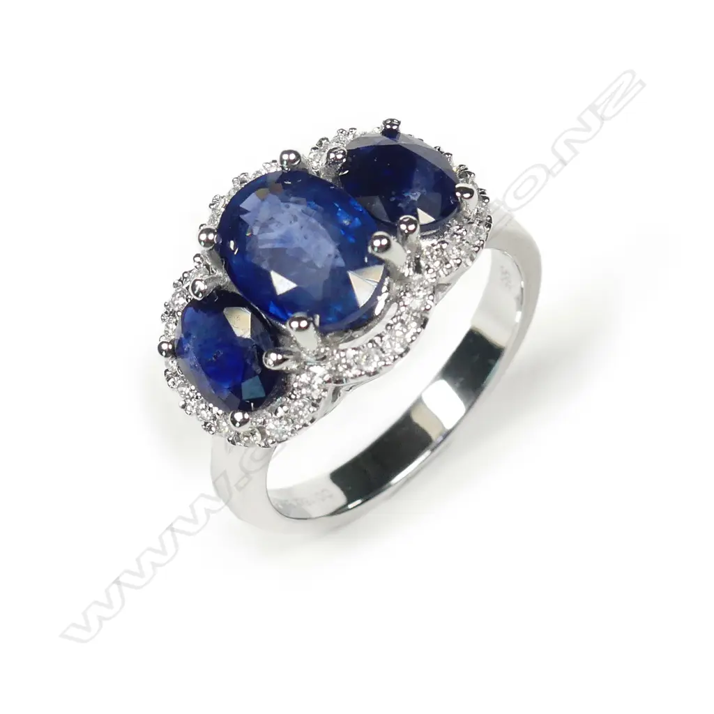 A 14ct white gold sapphire and diamond trilogy ring Image 1++