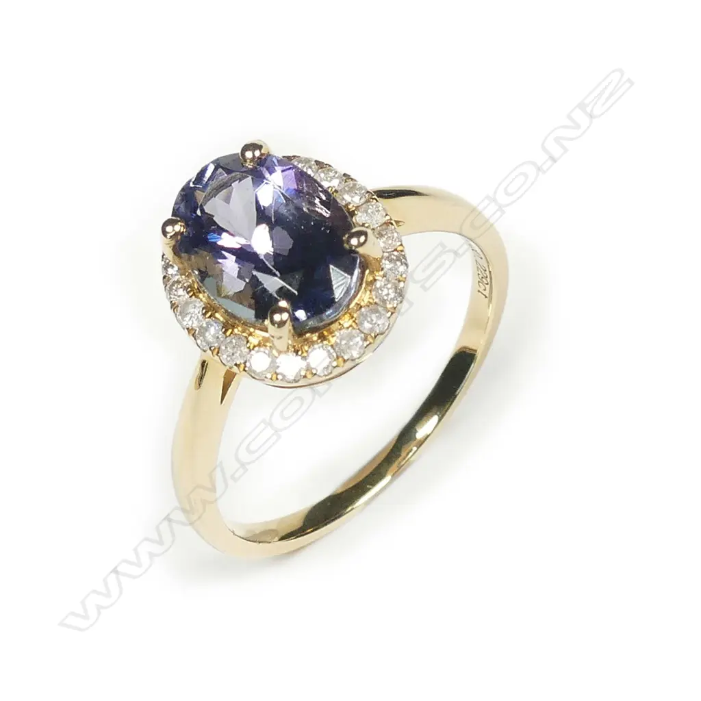 A 14ct gold tanzanite and diamond halo ring Image 1++