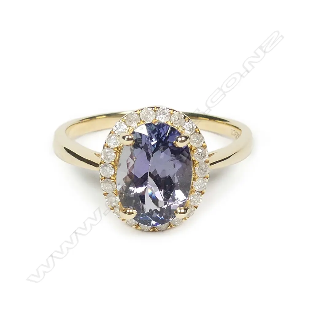 A 14ct gold tanzanite and diamond halo ring Image 1++