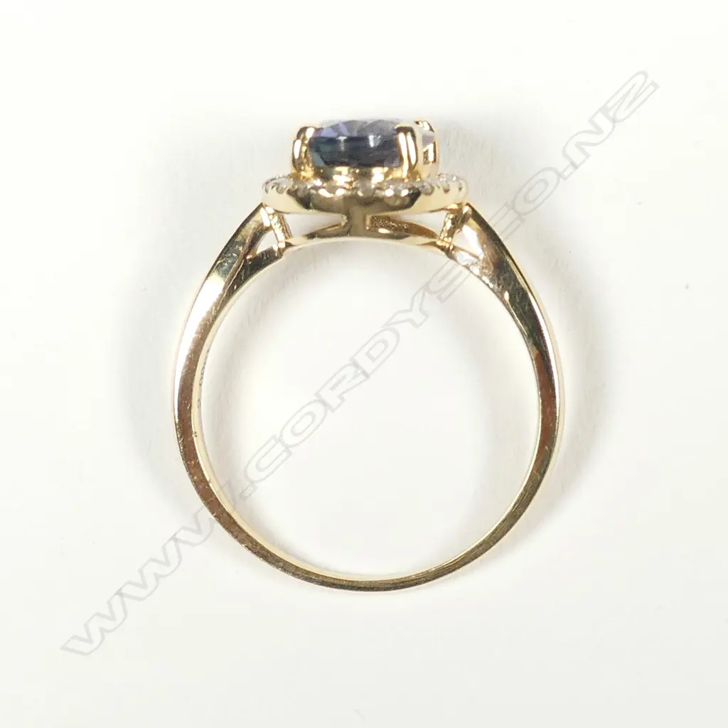 A 14ct gold tanzanite and diamond halo ring Image 1++